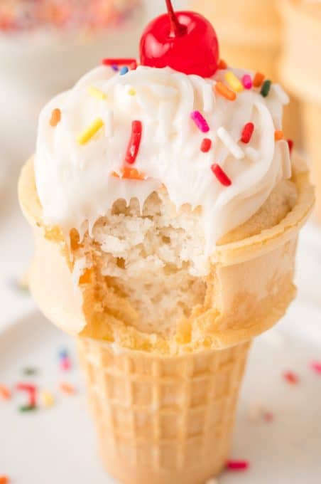 A bite taken out of a wafer cone cupcake.